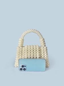 Handmade cream pearl beaded handbag with elegant top handle and textured spherical design