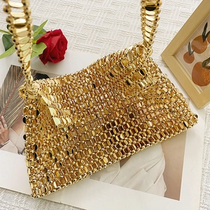 Detail shot of golden sequin woven handbag showing metallic texture and round plate design