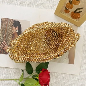 Detailed macro view of high-shine gold beaded texture and handmade woven hollow metal mesh