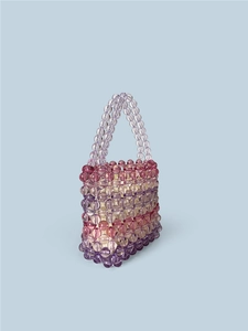 Rainbow gradient beaded handbag made of transparent acrylic beads with a top handle