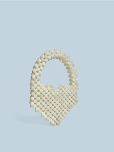 Beige beaded heart shaped tote bag with top handle and woven pearl texture