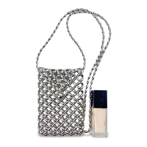 Dettaglio mini borsa a tracolla argento con perline metalliche e fibbia rotonda