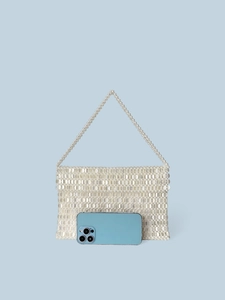 Elegant white beaded handbag with woven design and top handle shown with phone for size