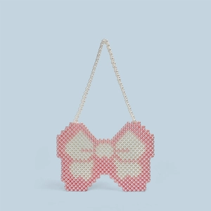 Detail of handmade pink and white beaded bow bag with delicate beaded handle
