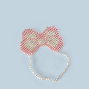 Detail of handmade Y2K butterfly beaded bag with pink pearls and intricate woven texture