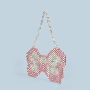 Detail of handmade butterfly beaded bag with pink and white pearls for summer style
