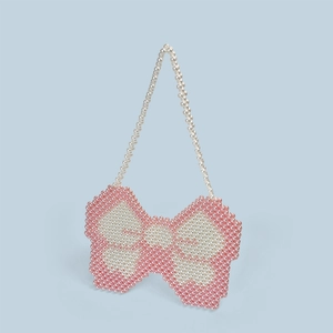 Detailed view of handmade Y2K bow-shaped beaded bag with pink and white pearls