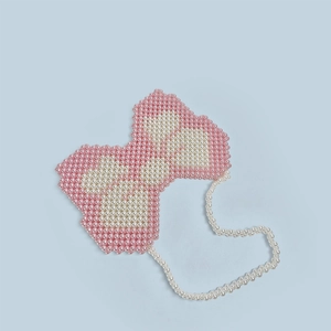 Detail showing handcrafted pink and white beaded butterfly bag with pearl strap