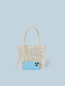 Handmade cream pearl beaded tote bag with sequins shown alongside a phone for scale