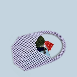 Top view of purple beaded handbag showing capacity for phone, lipstick, and compact