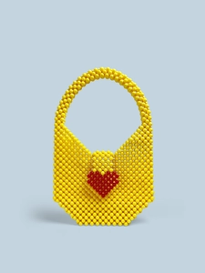 Detailed handmade yellow beaded tote bag featuring a red heart pattern on the front