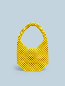 Detail of yellow handmade acrylic beaded bag with vintage candy color finish