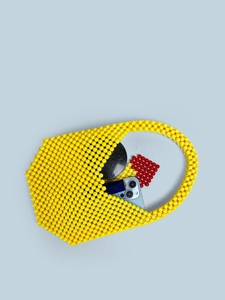 Handmade yellow acrylic beaded shoulder bag with interior items showing capacity