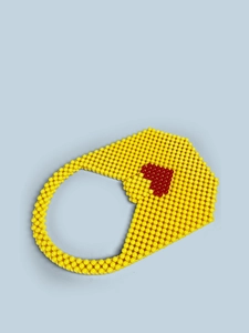 Detail of handmade yellow acrylic beaded handbag featuring a red heart pattern