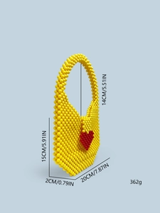 Detail of yellow beaded bag with red heart pattern showing dimensions and texture