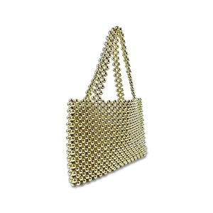 Detailed side view of handmade gold beaded tote bag with woven metallic luster beads