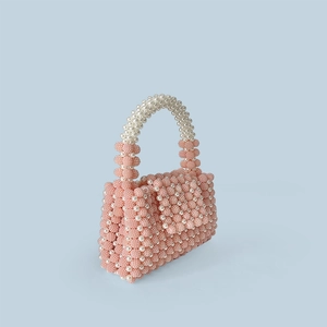 Detailed macro view of pink and white handmade beaded pearl handbag for evening
