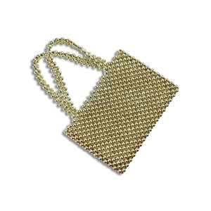 Macro detail of hand-woven gold metal beads on a luxury crystal pearl handbag