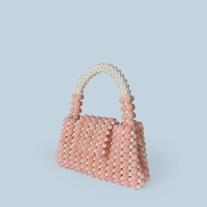 Detail of pink and white handmade beaded handbag showing textured pearlescent finish