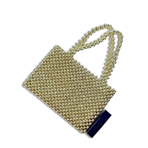 Detail of handmade gold metallic beaded bag with crystal pearls and elegant blue lipstick