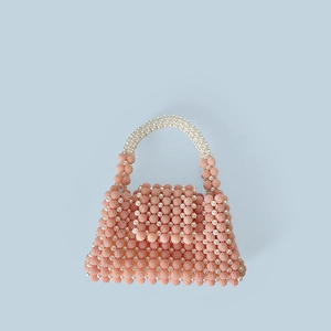 Close-up of handmade beaded handbag with pink and white pearlescent beads texture