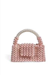 Detail of pink beaded texture and white pearl handle on handmade small handbag
