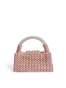 Macro detail of handmade pink and white pearl beaded handbag showing rich woven texture