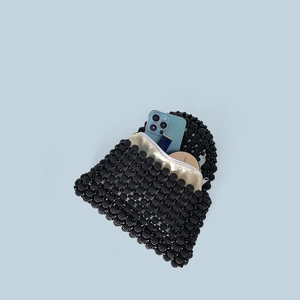 Top view of handmade black beaded handbag interior with champagne satin lining and zipper