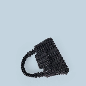 Macro shot of handcrafted black beaded handbag texture and precision beadwork pattern