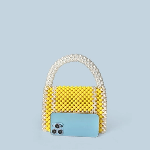 Detailed size comparison of hand-woven yellow beaded handbag with a smartphone