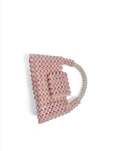 Detailed view of pink beaded handmade handbag with gradient handle and rich woven texture