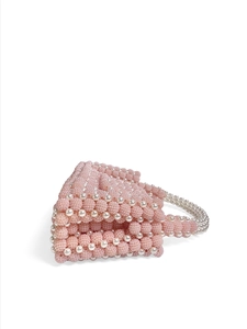 Detail of pink beaded handbag with pearl accents and textured 3D wave pattern