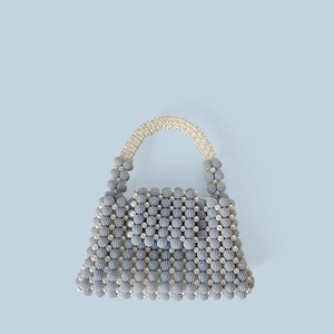 Close-up of handmade beaded handbag showing intricate blue and white pearl weave texture