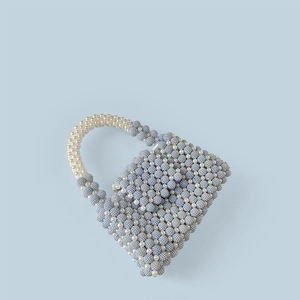 Close-up of handmade beaded handbag with blue matte and cream pearl textured weaving