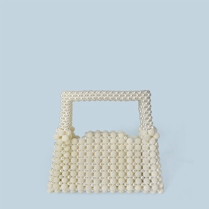 Detailed close-up of handmade pearl woven handbag showing texture and craftsmanship