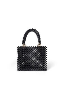 Detail of a handmade black beaded handbag featuring shiny resin beads and golden metal rings