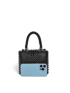 Macro shot of handmade black beaded handbag next to a smartphone for scale reference