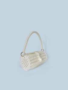 Elegant white pearl beaded cylindrical handbag with golden rings on light blue background