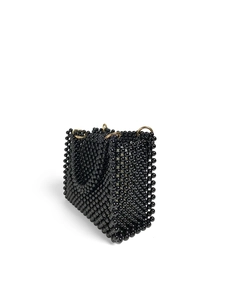 Detail of handmade black beaded handbag showing tight weave and gold metal rings