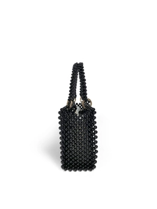 Detail of handmade black beaded handbag featuring glossy round beads and gold metal rings