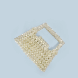 Detailed view of ivory handmade beaded pearl handbag with textured weave pattern