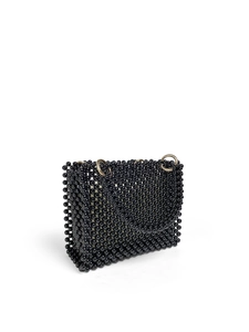 Detail of handmade black beaded handbag with glossy beads and gold metal ring buckle