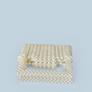 Detailed top view of handmade pearl beaded handbag featuring secure white zipper closure