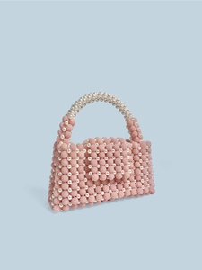 Elegant pink and white pearl beaded handbag with a top handle and textured woven surface