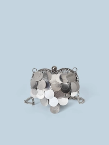 Close-up of heart-shaped silver sequin crossbody bag with chain and round bead clasp