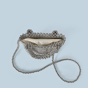 Detail view of silver pearl handbag with satin lining and zip closure