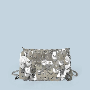 Detailed view of layered silver sequin pattern and metallic chain on the shoulder bag