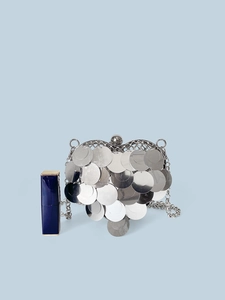 Macro view of silver heart-shaped sequin purse with metal scales and chain strap detail