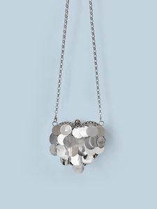 Close-up of heart-shaped silver sequin crossbody bag with metallic scale texture and chain