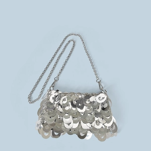 Detailed close-up of shiny silver sequin chain bag with metallic fish scale texture